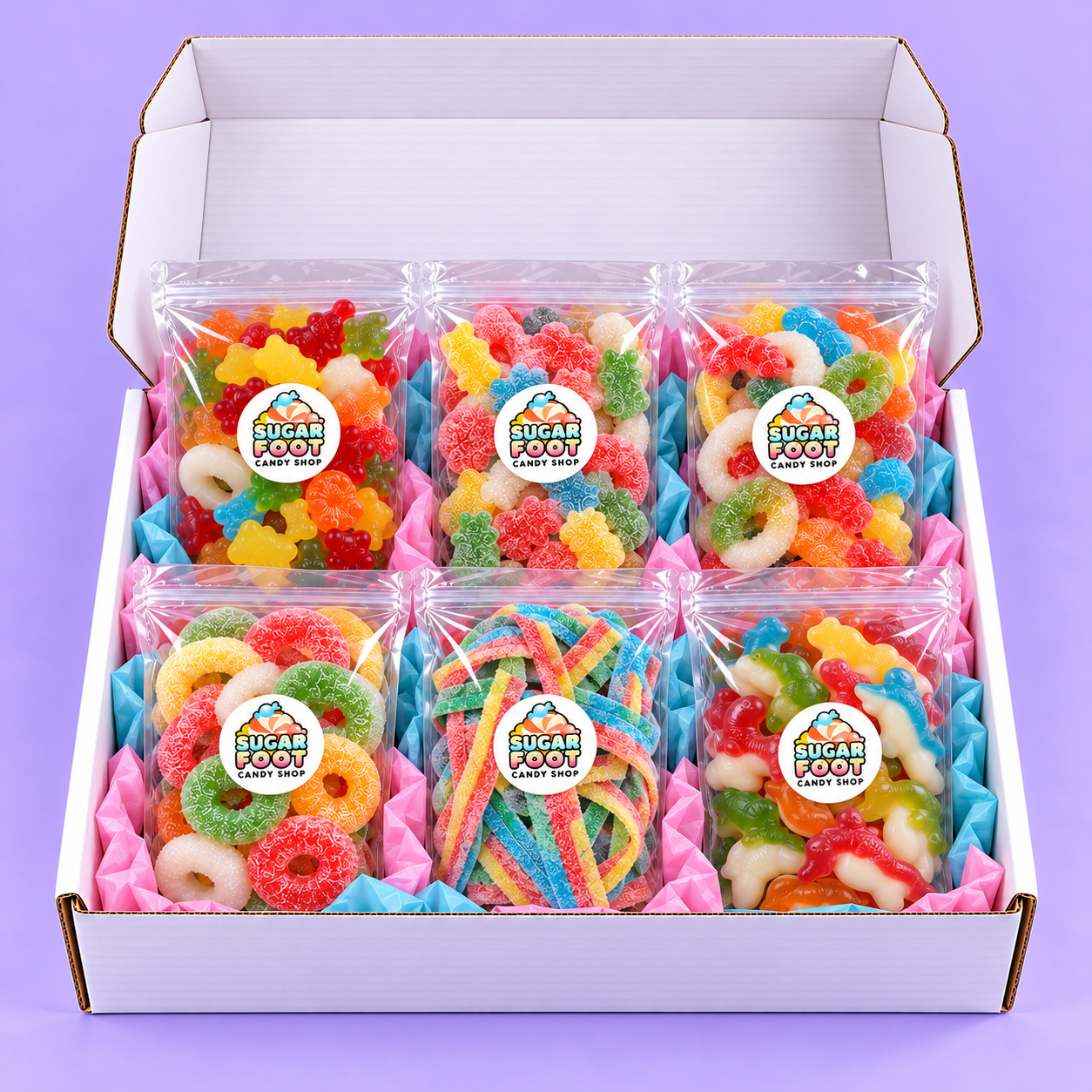 Open Sugarfoot Big Candy Box with six large candy bags on a lavender background